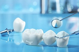 Dental implant and dental bridge parts next to dental tools