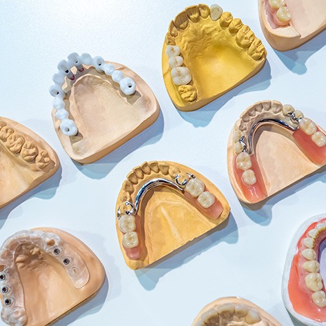 Various types of dentures against a blue background