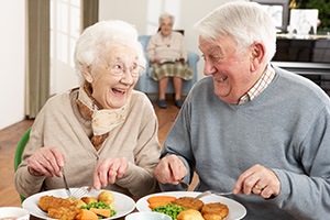 Older man and woman eating together
