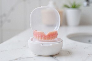 A full upper denture in a protective case