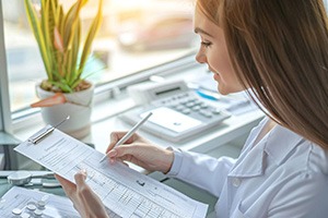 Woman completing paperwork for an alternative payment method