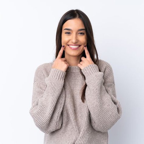 Cosmetic dentistry patient looking at her smile in mirror