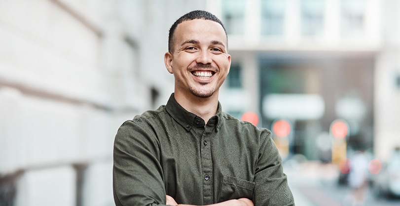 Happy, confident man in downtown setting